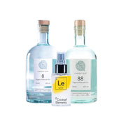 Two Linden Leaf Organic Molecular Gin bottles with cork stoppers, one labeled '8' and one labeled '88', with lemon Cocktail Elements spray bottle positioned between them on white background